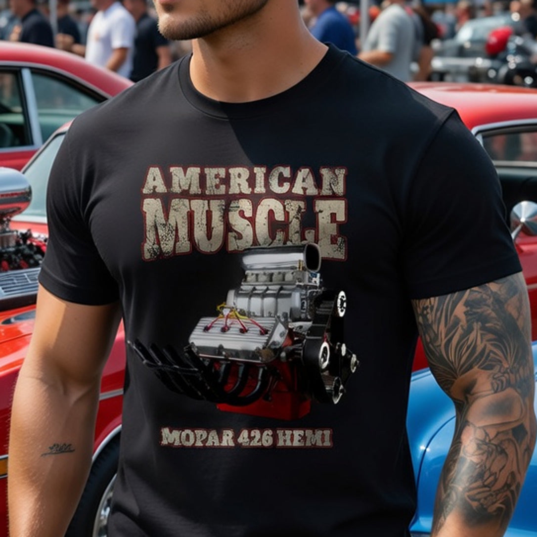 Man wearing a black t-shirt with 'American Muscle' and MOPAR 426 HEMI design at a car show.