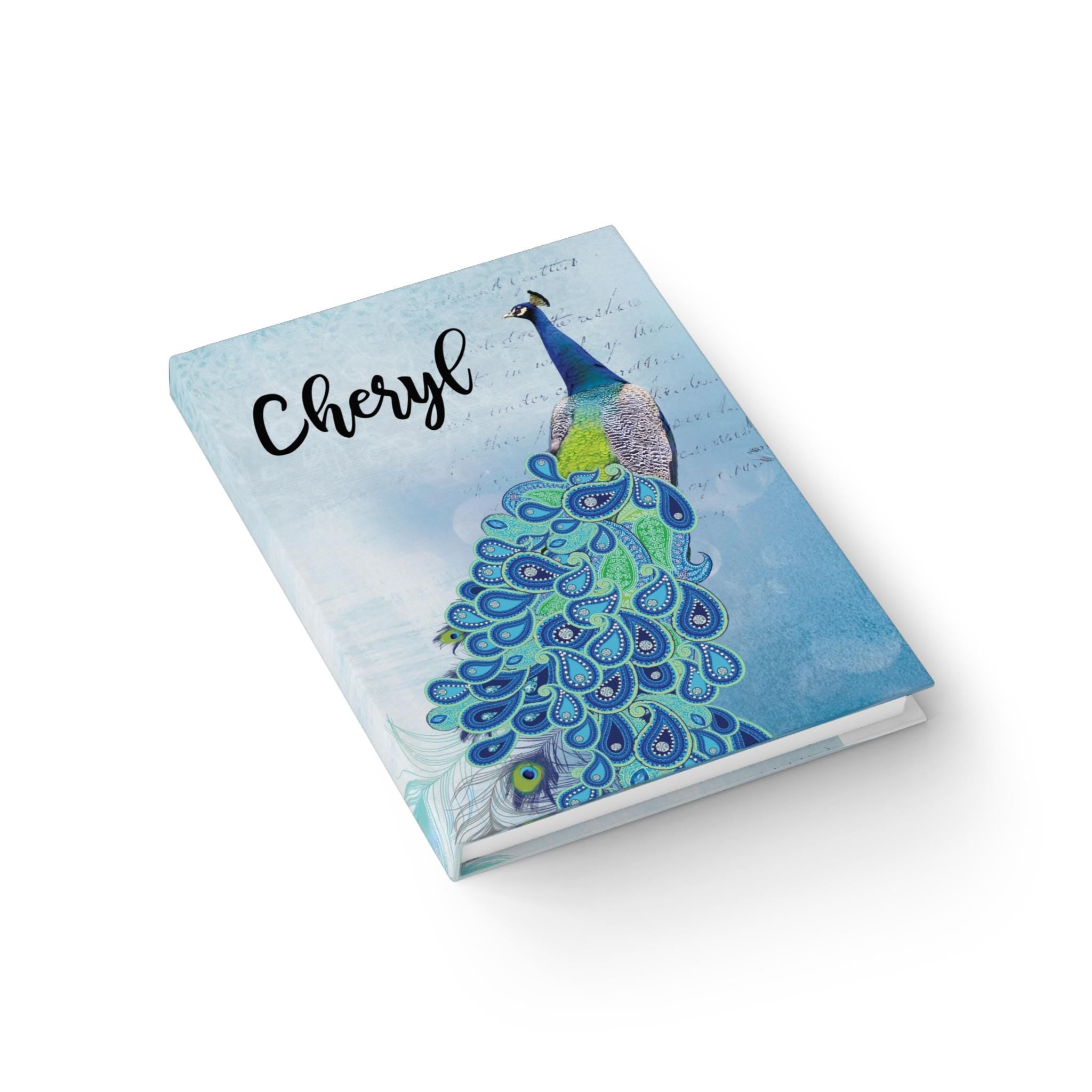 Blue peacock journal with a customized cover showing a vibrant peacock illustration and the name 'Cheryl'.