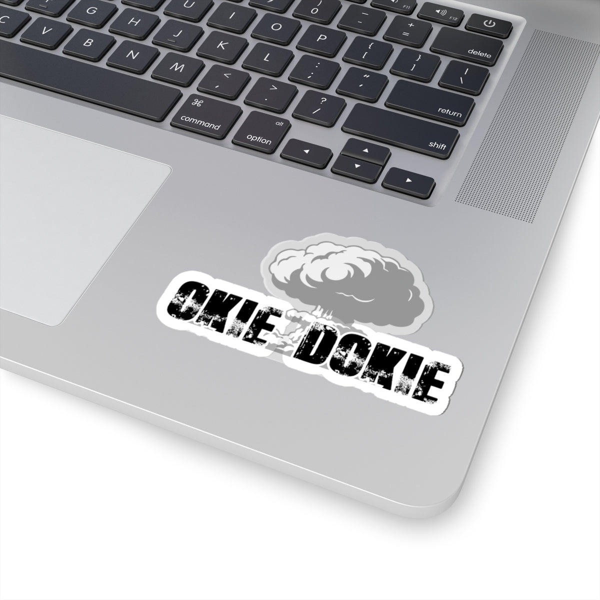 Laptop with a 'Okie Dokie' sticker on the palm rest area