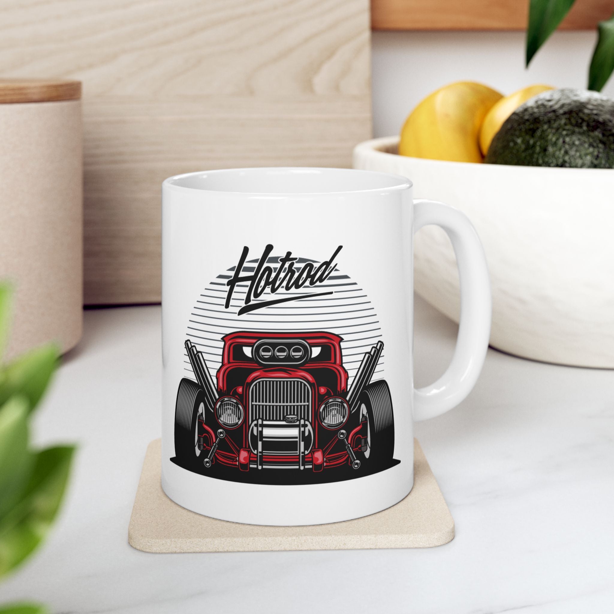 White mug with a red car graphic and 'Hotrod' text on a white surface.