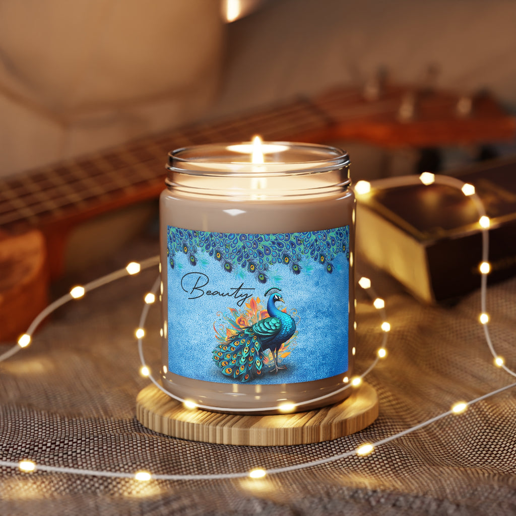 Candle with a peacock design label on a wooden coaster, surrounded by string lights and a guitar in the background.