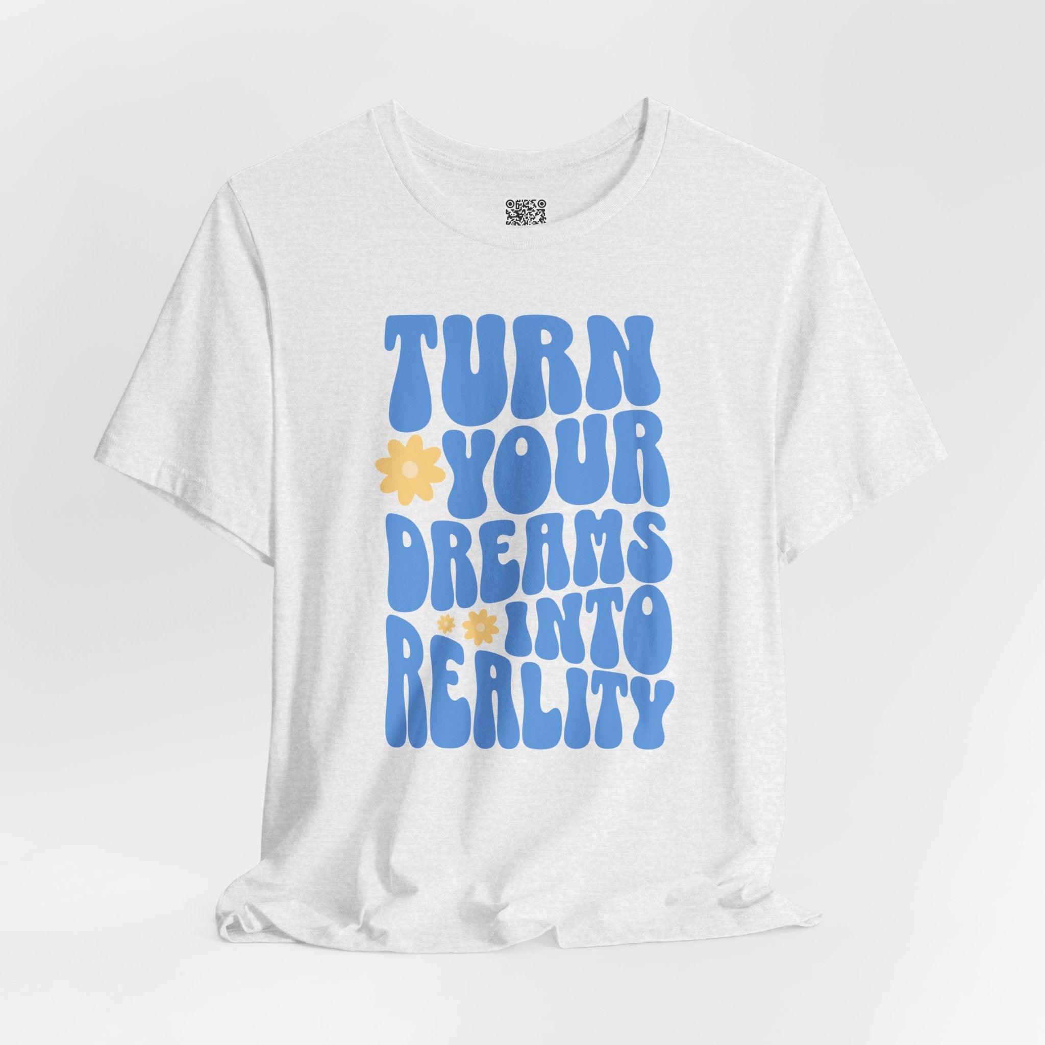 White Retro Flower Positive Message T-Shirt with blue text and yellow flowers, reading "Turn Your Dreams Into Reality".