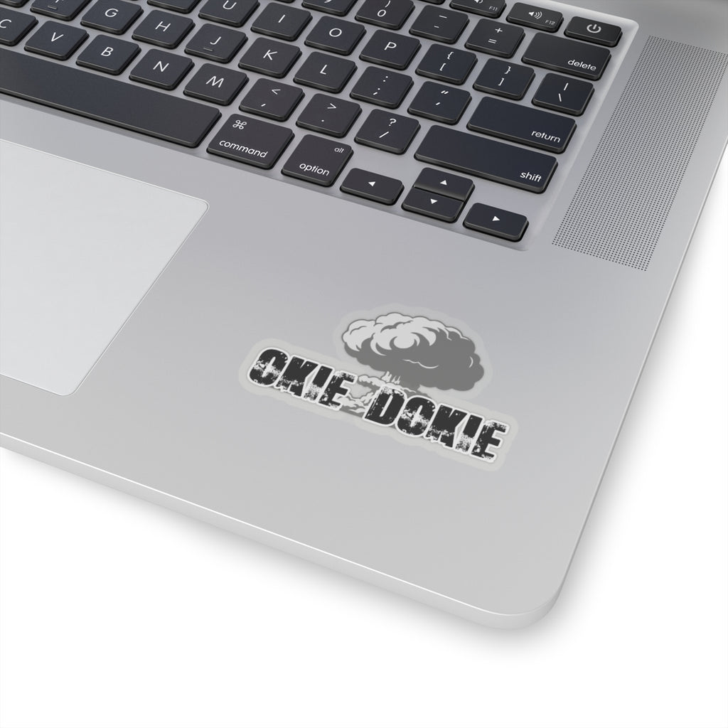 Laptop with a sticker on the palm rest area featuring a logo and okie dokie text.