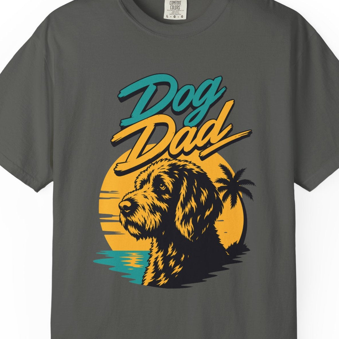 Gray t-shirt with 'Dog Dad' graphic design featuring a dog and sunset on a white background
