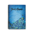 Notebook with peacock design and 'Your Name' text on a blue background