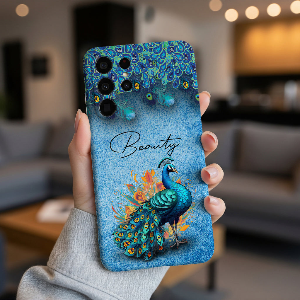 Blue peacock phone case with 'Beauty' text, held in hand, showing vibrant illustration and tough protection