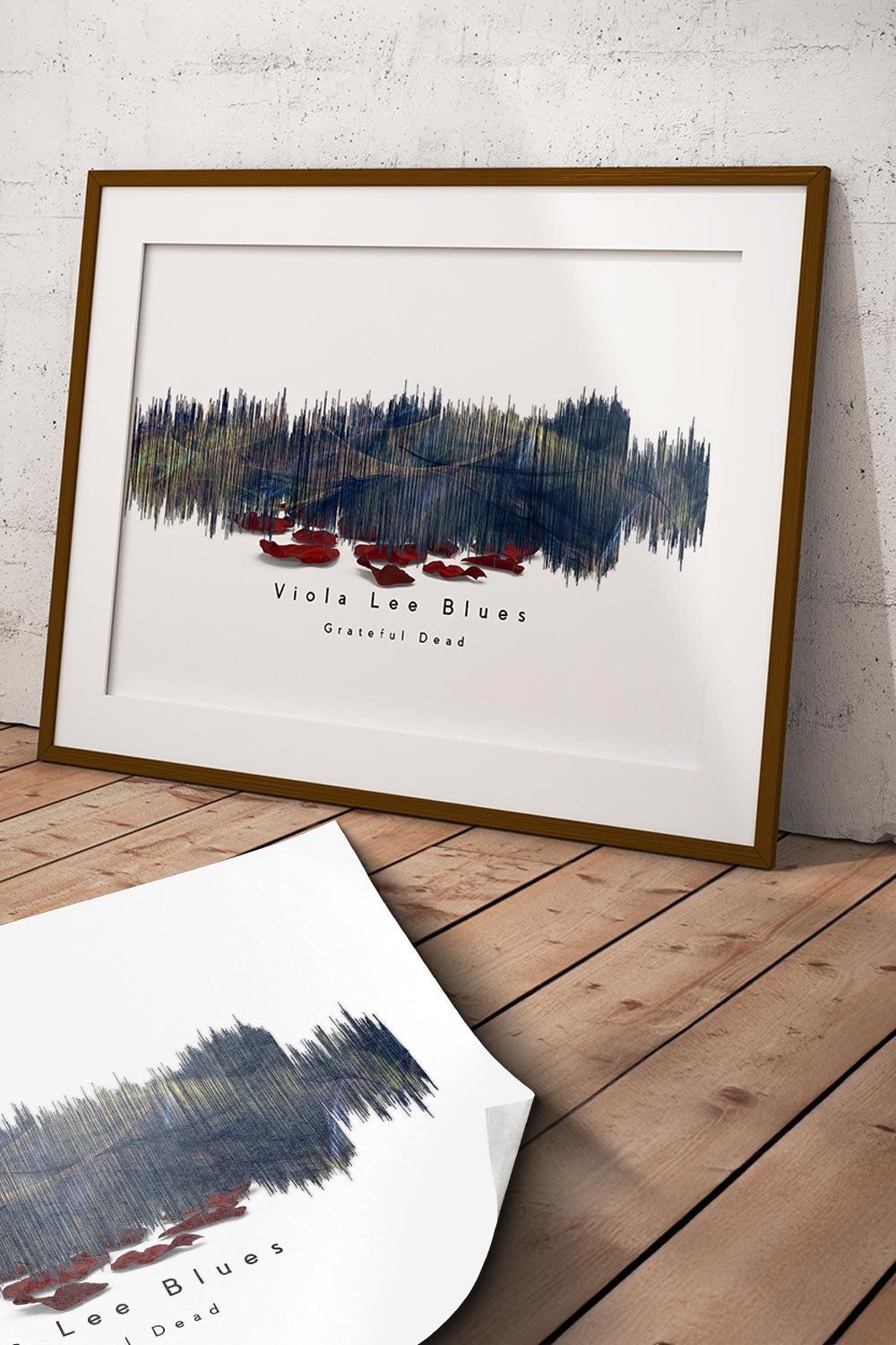 Framed artwork on a wooden floor with a white wall background