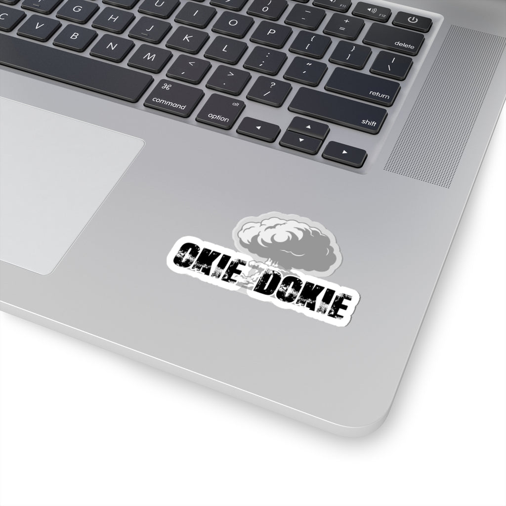 Laptop with a sticker on the palm rest area featuring okie dokie text and a logo.