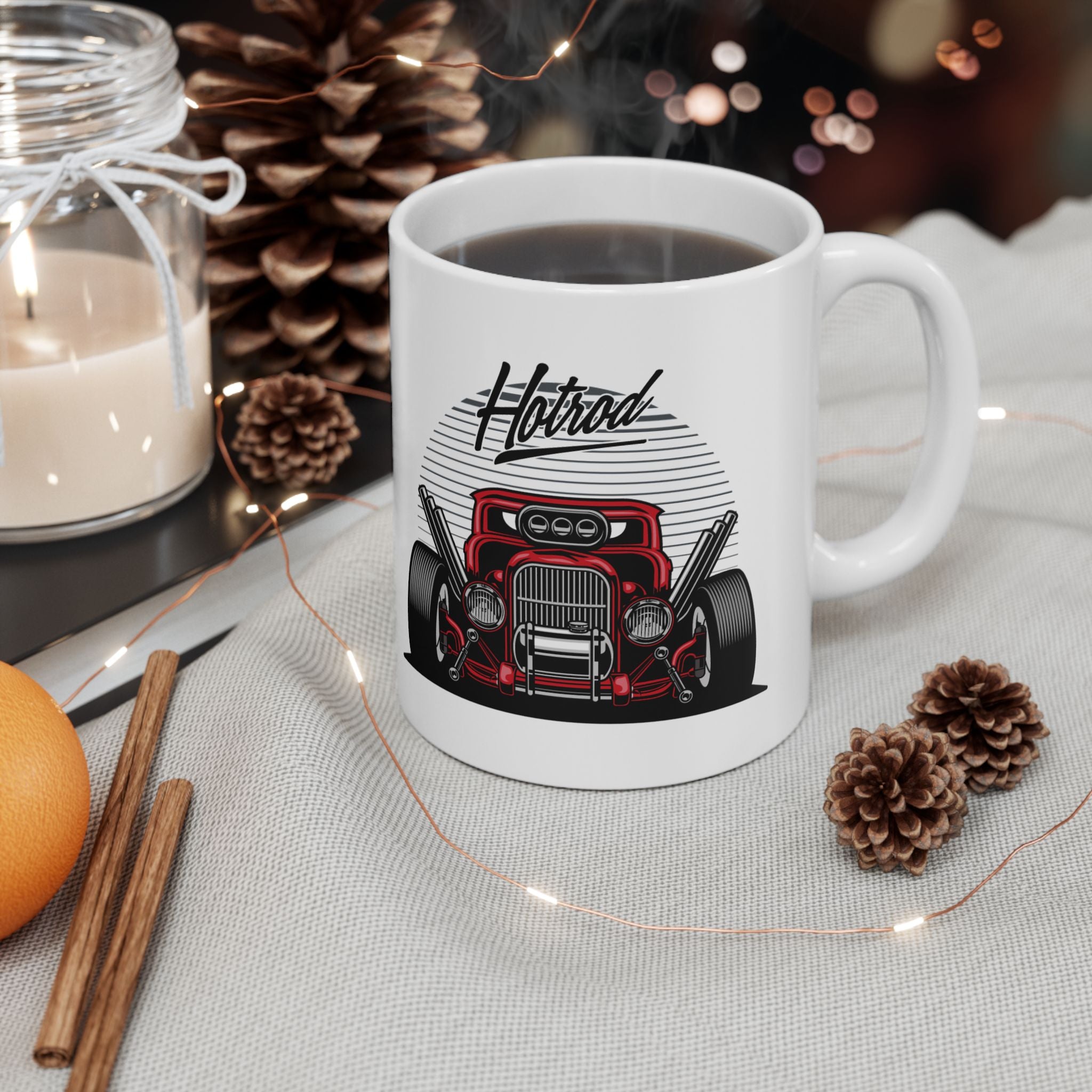 White mug with car design on a table with decorative items
