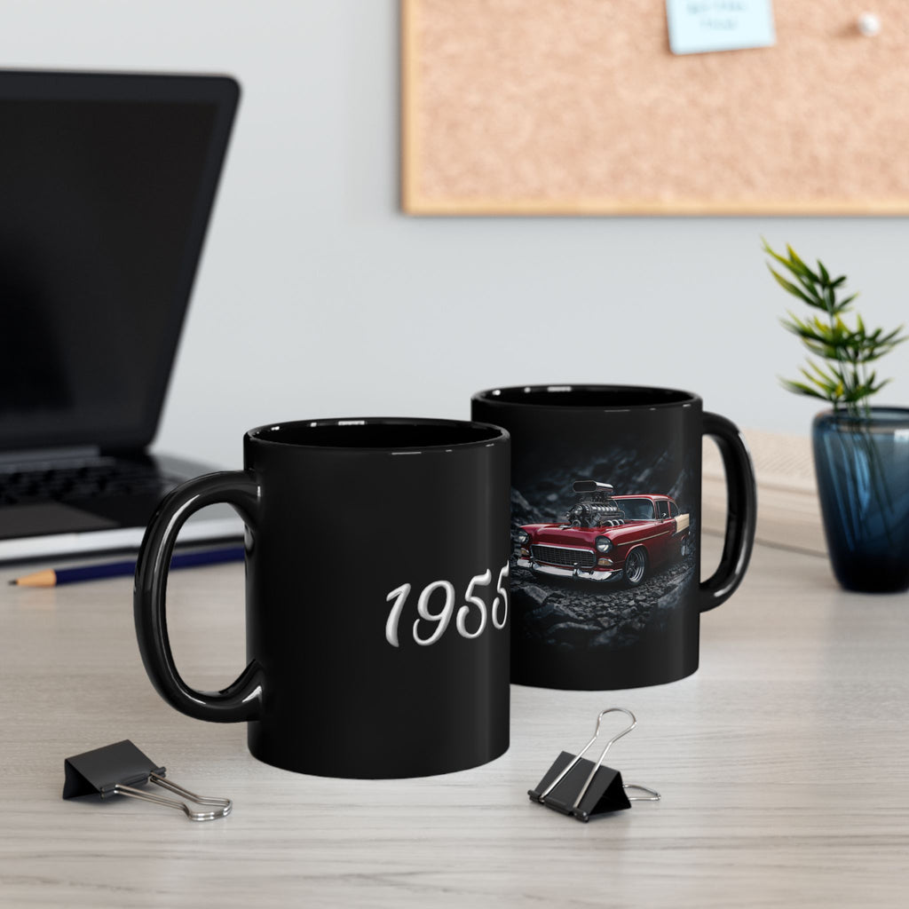 Two black mugs on a desk with one displaying '1955' and the other featuring a classic car design.