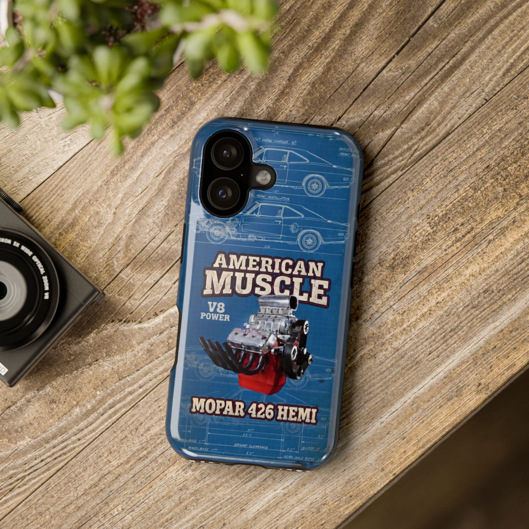 Phone case with 'American Muscle Mopar 426 Hemi' design on a wooden surface