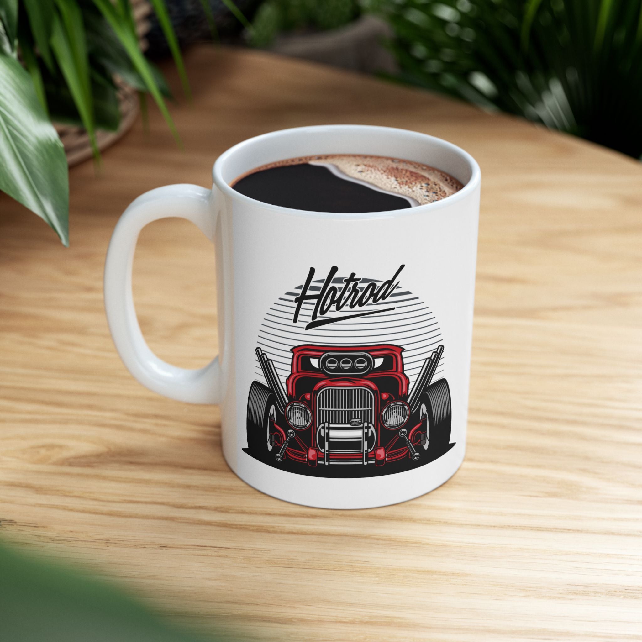 White mug with a red car graphic and 'Hotrod' text on a wooden table.
