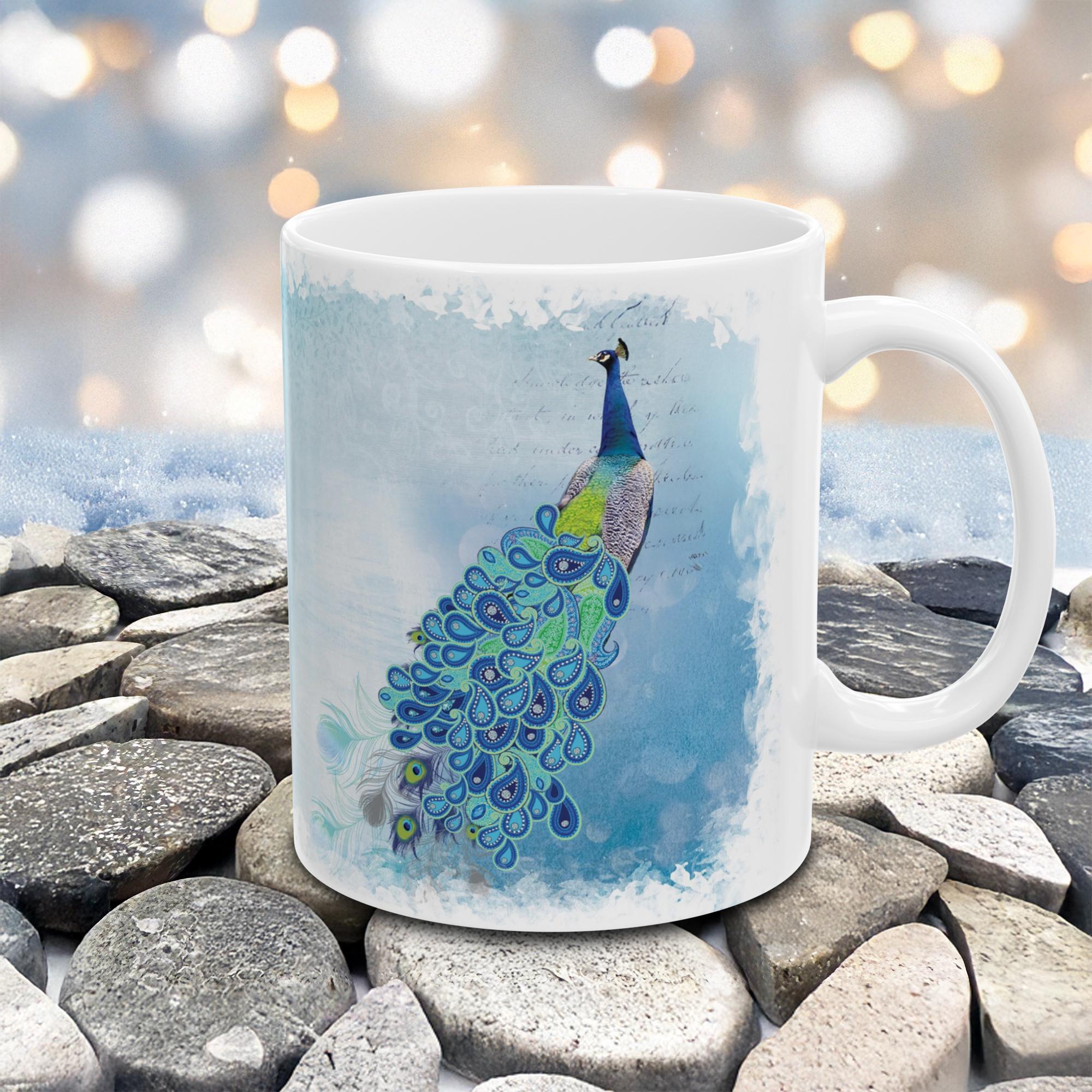 Mug with peacock design on a stone surface with blurred lights in the background
