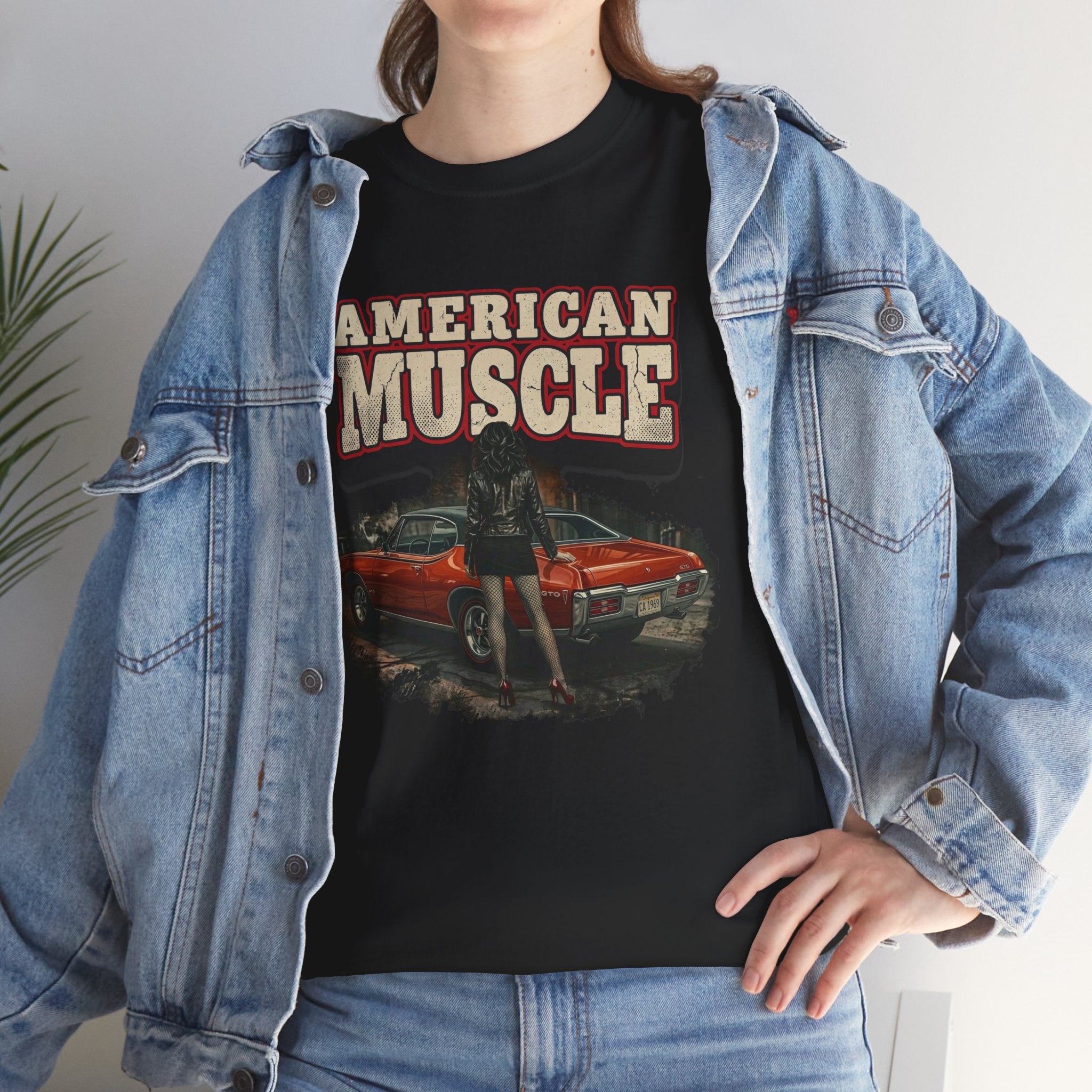 Person wearing a black t-shirt with 'American Muscle' graphic design, paired with a denim jacket.