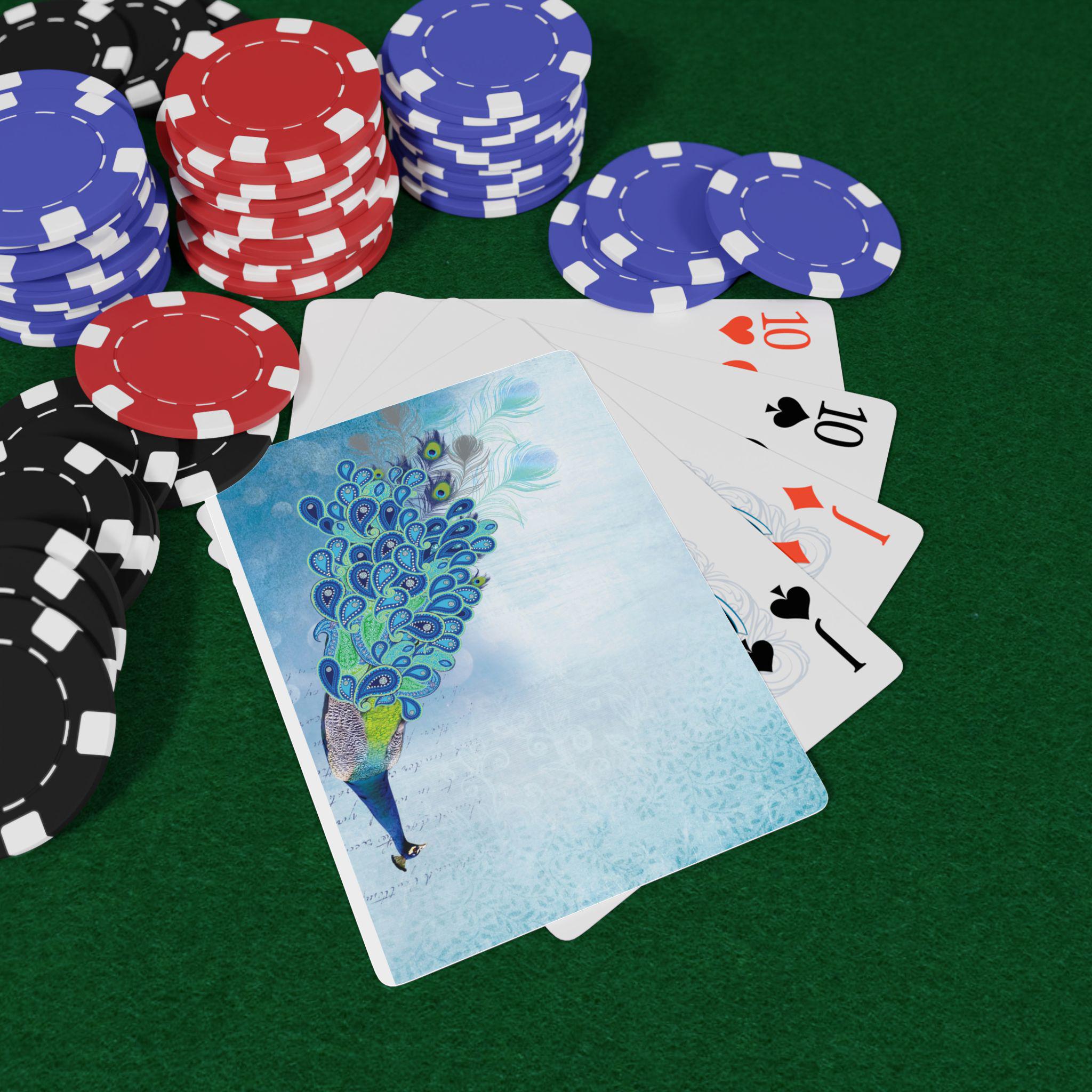 Peacock poker deck with vibrant design on card back, fanned playing cards, red & blue poker chips on green felt