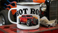 White mug with 'Hot Rod' and car illustration on a red toolbox with a vintage car in the background