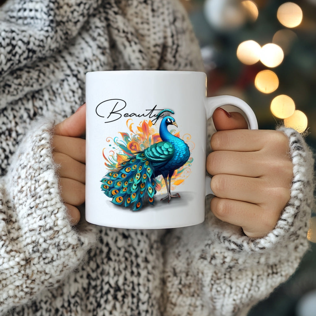 Person holding a mug with a peacock design and 'Beauty' text, blurred lights in the background