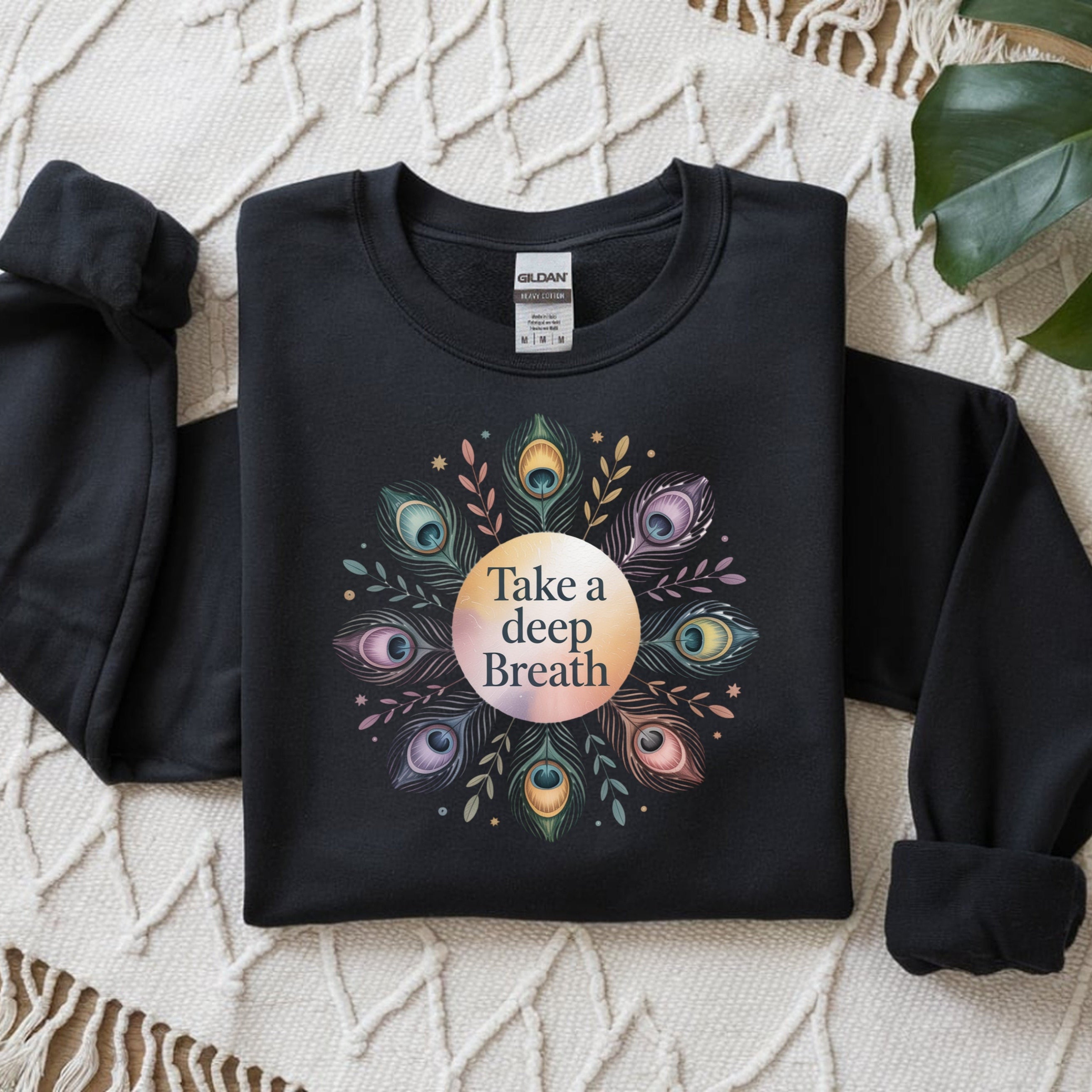 Black sweatshirt with a colorful design and 'Take a deep Breath' text on a textured surface.