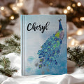 Personalized journal with a blue peacock design and custom name option, perfect for writing and sketching.