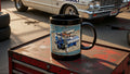 Vintage car with 'Thunderbolt' branding in a garage setting, featuring a mug on a tool chest.
